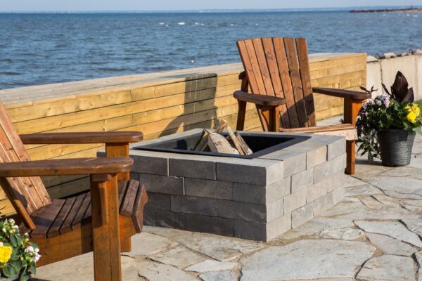 Ocean side backyard setting featuring Shaw Brick's Classic Weathered WallStone proucts around firepit